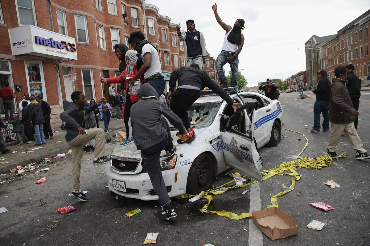 Riots During a riot, youths destroy a police car