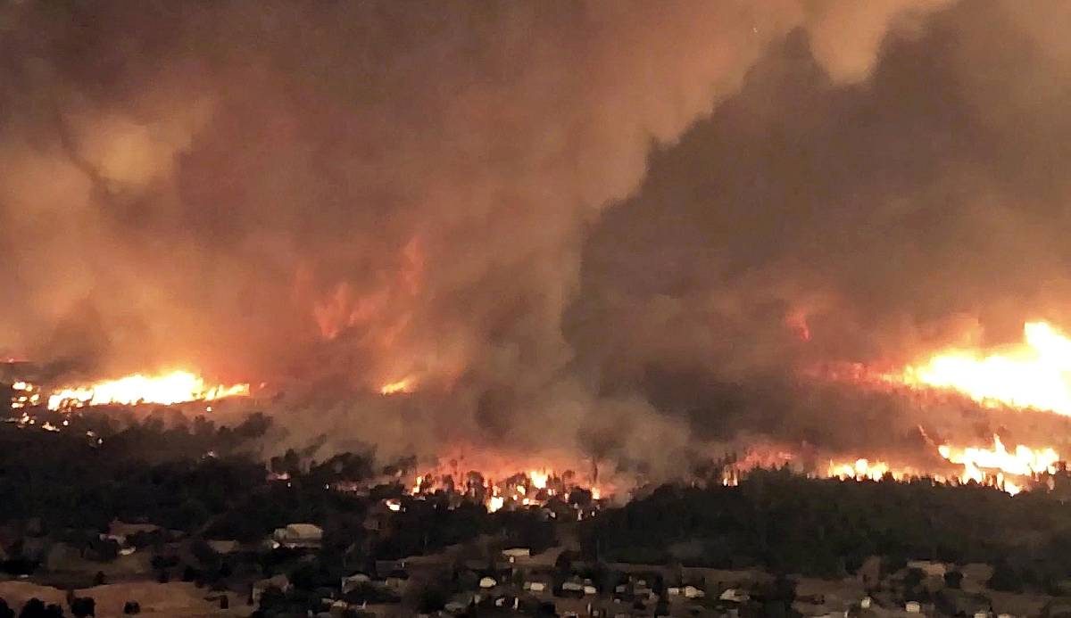 Wildfires Raging wildfire advances towards a town