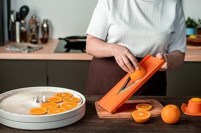 Slicing food to dehydrate in a kitchen oven